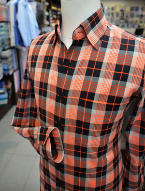 A black and orange check Anto sport shirt, showcased on a mannequin.
