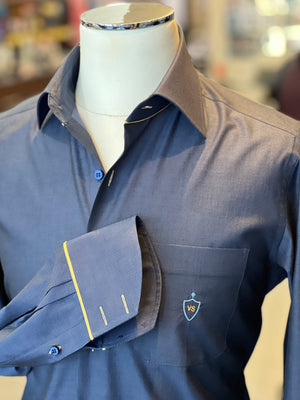 Anto blue dress shirt with yellow detail and crest initial embroidery, showcased on a mannequin.
