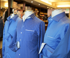 Three different blue styled shirts displayed on a mannequin, showcasing varying designs and styles.