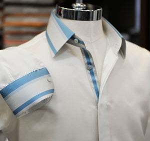 A white Anto shirt with blue stripe detail on collar, front, and cuffs. Showcased on a mannequin.