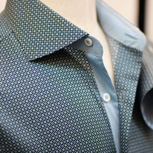 Dark green polka dot Anto shirt on a mannequin, with a focus on the collar and front detail.