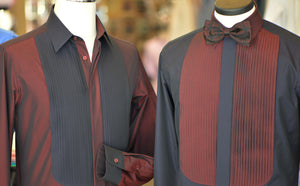 Two Anto tuxedo shirts on individual mannequins: one with red pleats and a black body, and the other with black pleats and a red body.