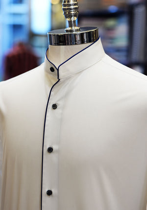 Anto white band collar shirt with blue piping and buttons, showcased on a mannequin.