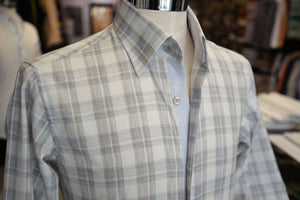 A white, gray, brown check sport shirt, showcased on a mannequin.