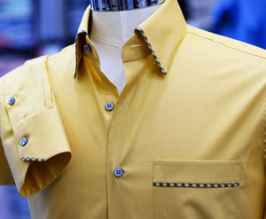 A yellow Anto sport shirt with detail trims, showcased on a mannequin.