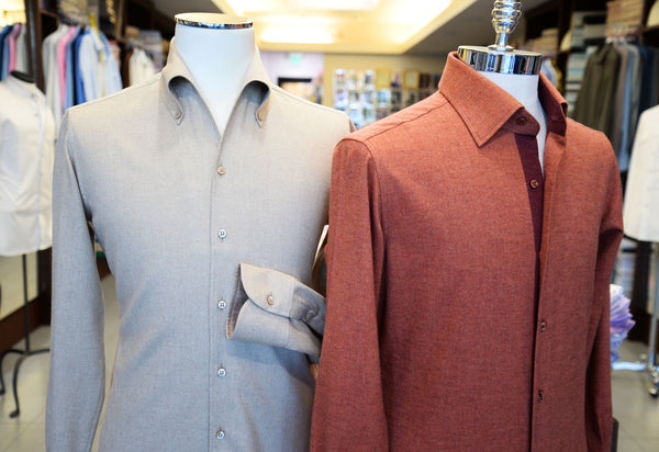 beige flannel shirt and orange flannel shirt on a mannequin